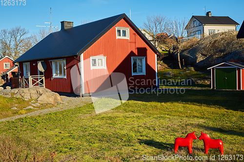 Image of Red house at sea shore in the baltic sea in dull colors in autumn.