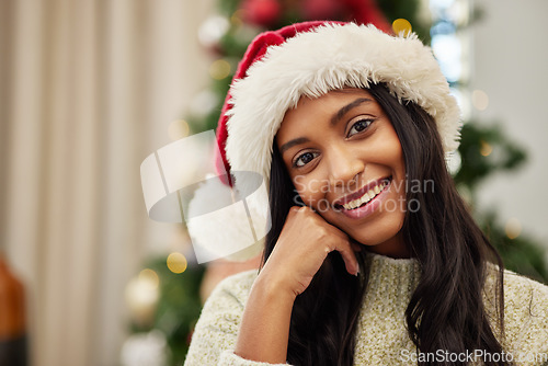 Image of Happy woman, portrait and Christmas hat for celebration, festive season or gift giving time at home. Face of female person with smile in relax for holiday, weekend or December party by tree in house