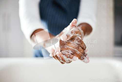 Image of Hands, cleaning and soap with hygiene in bathroom, safety from bacteria and germs, disinfection and skincare. Health, wellness and person at home, sanitizer foam to clean and healthy with handwashing