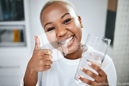 Image of Thumbs up, yes and portrait of black woman with water for diet success or detox start. Happy, healthy and an African girl with an emoji hand for liquid goal or care with a glass in the morning