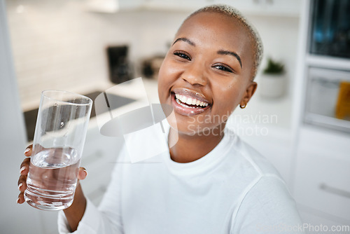 Image of Portrait, glass and black woman drinking water, smile and health with joy, nutrition and laughing. Face, female person or happy girl in her kitchen, liquid and home with happiness, wellness and detox