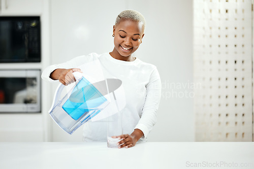 Image of Woman, pitcher and glass of filter water to refresh in liquid purification treatment at home. Happy black female person pouring healthy aqua beverage for nutrition, drink or filtration jug in kitchen