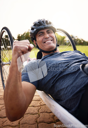 Image of Portrait, cycling and a winner man with disability in celebration of success in a sports competition. Exercise, smile and motivation with a young male cyclist athlete on a custom bike for training