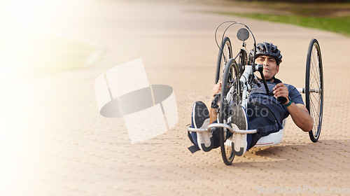 Image of Man with disability, handbike and outdoor bicycle for sports, race or exercise power with flare of mockup space. Fitness, male athlete with paraplegia and cycling in competition, challenge or contest
