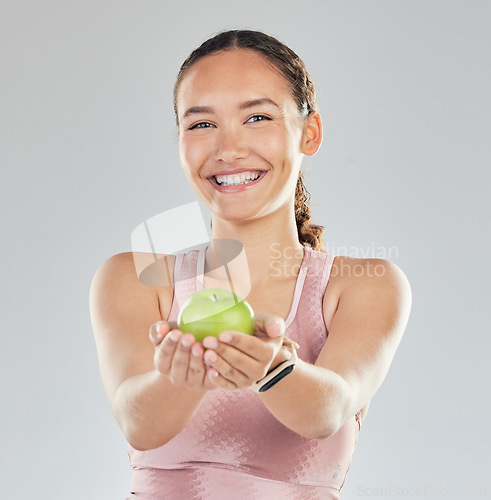 Image of Portrait, apple and offer of woman isolated on studio, white background for healthy food, healthcare or nutritionist diet. Face of vegan person or model giving green fruit for detox, care and choice