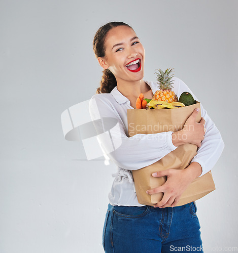 Image of Excited, portrait and woman grocery shopping for fruit on mockup space in studio isolated on a white background. Bag, food or customer with vegetables for nutrition, healthy diet and supermarket deal
