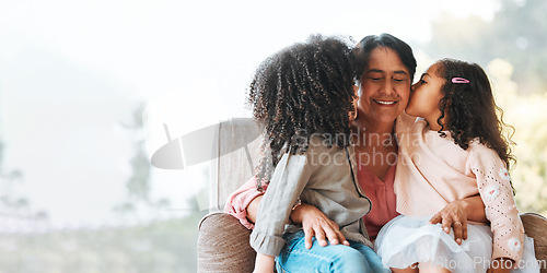 Image of Family, kiss and grandmother with children on a sofa happy, sweet and bond in their home. Love, kissing and senior woman with girls kids in living room hug, having fun and enjoying weekend together
