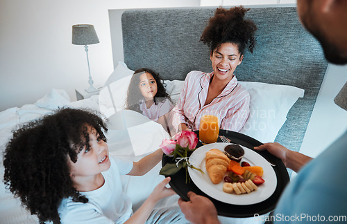 Image of Happy family, mothers day and morning breakfast in bed for celebration, love and care together at home. Father and children giving mom food, meal or gift for start, holiday or weekend in the bedroom