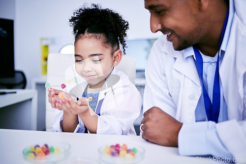 Image of Science, research and child with her father in the lab working on an experiment or test with sweets. Biology, candy and girl kid student doing project with dad scientist in pharmaceutical laboratory.