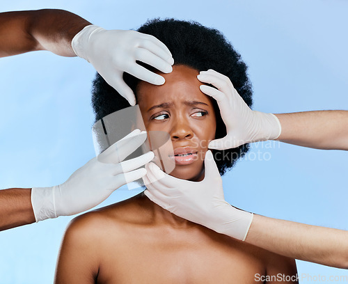 Image of Confused, hands and black woman with check on a blue background for surgery or dermatology problem. Frustrated, African girl and doctors and inspection of skin for botox isolated on a studio backdrop