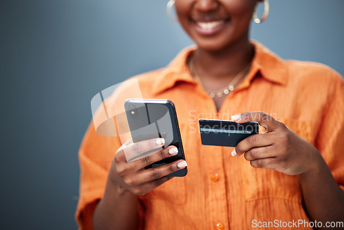 Image of African woman, credit card and phone in studio with e commerce, digital payment or smile by background. Girl, smartphone and fintech with online shopping, bills and cybersecurity with typing password