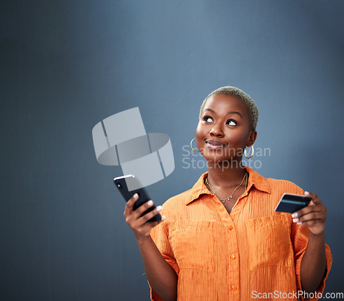 Image of Thinking, ecommerce and credit card with a black woman using her phone in studio on a gray background. Mobile, online shopping and finance payment with a female shopper searching for a deal or sale