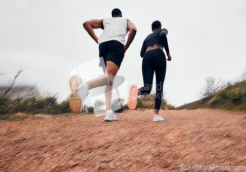 Image of Running couple, dirt path and fitness with workout and training on a race and marathon. Runner, young people back and road on a exercise challenge outdoor with sport cardio performance in nature