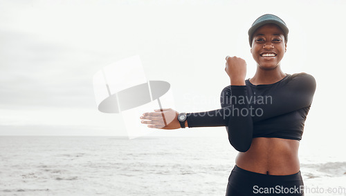 Image of Portrait of woman stretching by ocean for fitness in nature for exercise, marathon training and running. Sports, mockup and African female person stretch arms for warm up, cardio workout and wellness