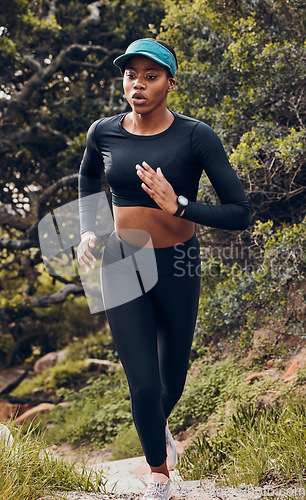 Image of Fitness, black woman and workout in forest for health wellness in sportswear. Commitment or exercise, motivation or running and African female athlete training for marathon in woods outdoor.