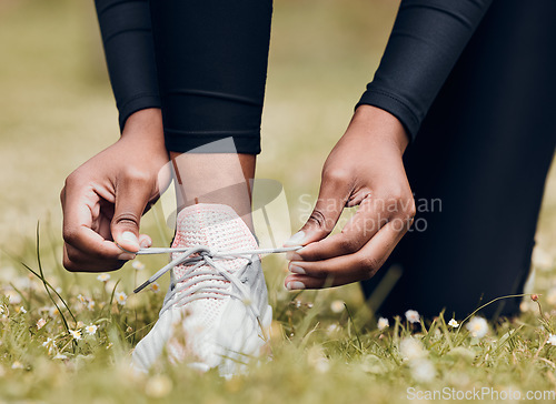 Image of Lace sneakers, person and hands outdoor on grass for running, workout and performance. Closeup of athlete, runner and tie shoes on feet, footwear and exercise at park for sports, fitness and marathon
