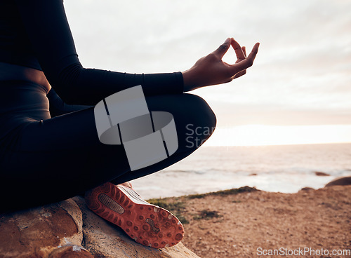 Image of Lotus pose, hands and yoga at the beach, fitness and meditation, spiritual wellness with person in nature. Exercise, zen and yogi on rock outdoor with holistic healing and calm, sea and mindfulness