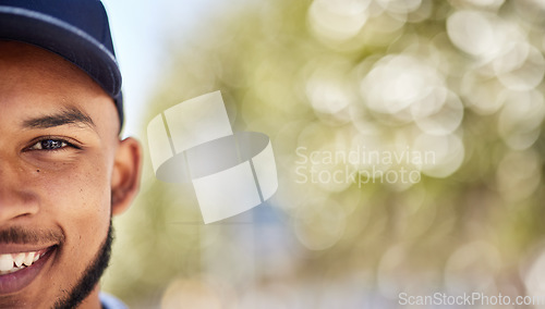 Image of Portrait, mockup and blurred background with a man in nature, outdoor during summer for adventure. Half face, smile and green space with a happy young male person wearing a cap during the day