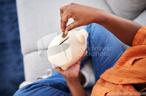 Image of Woman, hands and coins in piggy bank for savings, finance or money investment on sofa at home. Hand of female person with piggybank for financial freedom, cash growth or budget planning at the house