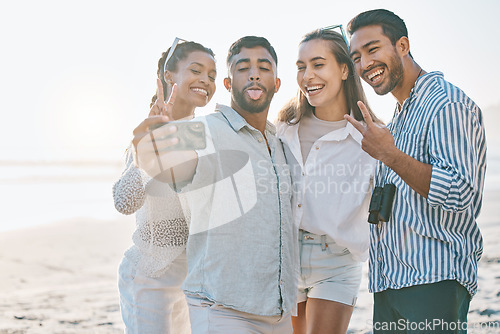 Image of Happy friends, selfie and beach for memory, photo or picture in goofy or silly fun together in nature. Group of people with smile and peace sign on ocean coast for vlog, online post or social media