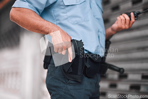 Image of Closeup, law or police officer with a gun, safety or career with legal enforcement, armed or crime. Zoom, man or security guard with service weapon, protection or danger with walkie talkie or uniform