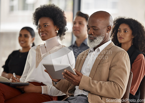 Image of Seminar, listening or business people writing notes in meeting for education or coaching in company. Mentorship, learning or employees in group training presentation with tablet or notebook in office