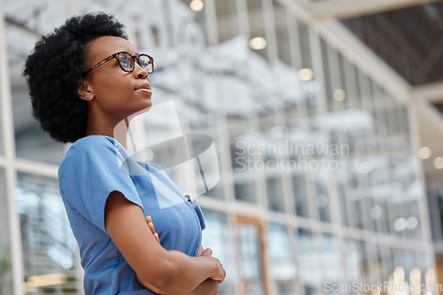 Image of Nurse, arms crossed and thinking with black woman in hospital for medical, idea and expert. Medicine, healthcare and nursing with female person in clinic for wellness, mockup space and surgery