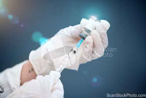 Image of Closeup, hands and vial with medicine, injection and needle with a doctor on a blue studio background. Zoom, gloves and medical professional with healthcare, needle and vaccine with pharma research