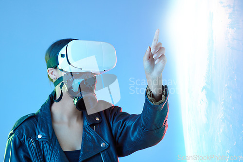 Image of Woman, point and virtual reality glasses in studio with holographic explosion, game or tech in metaverse. Girl, futuristic ar goggles and gas mask in digital transformation, vision or user experience