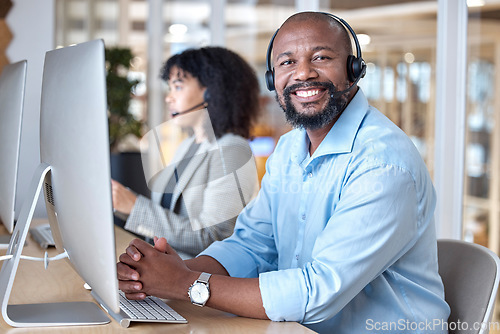Image of Call center, portrait of black man and smile at computer for customer service, business support and contact us in CRM office. Happy telemarketing agent at desktop for consulting in coworking agency