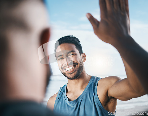 Image of Happy man, fitness and high five for success, partnership or victory in achievement after workout in nature. Male person or men touching hands in team building, motivation or exercise goals on beach