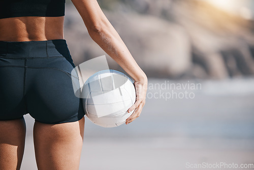 Image of Woman, hand and volleyball on beach in sports game, match or training exercise by ocean coast. Rear view of female person with ball in fitness for volley practice by sea or healthy wellness in nature