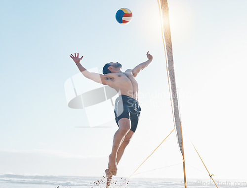 Image of Beach, exercise and man with fitness, volleyball and fun with sunshine, moving and healthy. Male person, athlete and player with seaside sports, game with speed or workout goals with sand or wellness