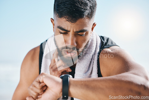 Image of Man, fitness and watch for pulse, heart rate or performance on break after workout, running or training. Fit, active and sporty male person checking wristwatch for monitoring body exercise in nature