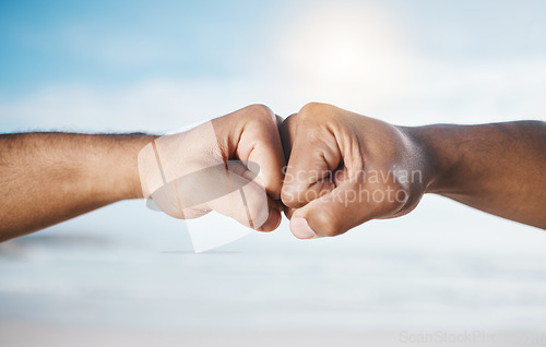 Image of Man, hands and fist bump for partnership, unity or collaboration in deal or agreement outdoors. Hand of men or friends bumping fists for community, mission or goals together in solidarity or success