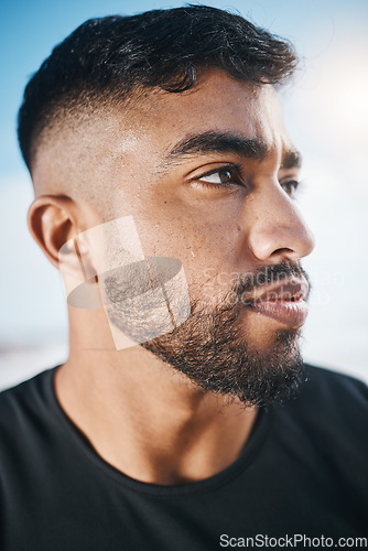 Image of Thinking, fitness and closeup of man for exercise, marathon training and cardio workout in nature. Sports, blue sky and face of Indian male person outdoors for wellness, healthy body and running