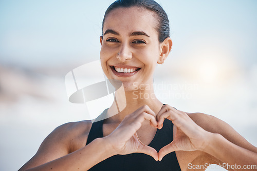Image of Woman, portrait and heart hands, fitness outdoor with love icon and emoji, happiness and health. Wellness, support and care with female athlete, exercise and symbol, hand gesture and feedback