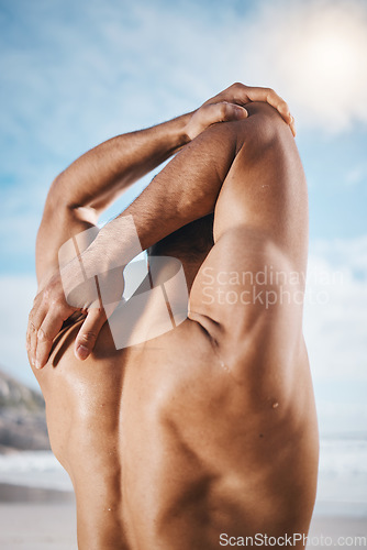 Image of Arm, stretching and back on man outdoor for training, running or workout at the beach. Hands, stretch and behind guy runner with body warm up in nature before exercise, run or cardio sport routine