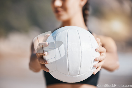 Image of Woman, hands and volleyball in fitness for sports, game or match on beach in training or practice in nature. Hand of active and sporty female person holding ball for playing volley on ocean coast