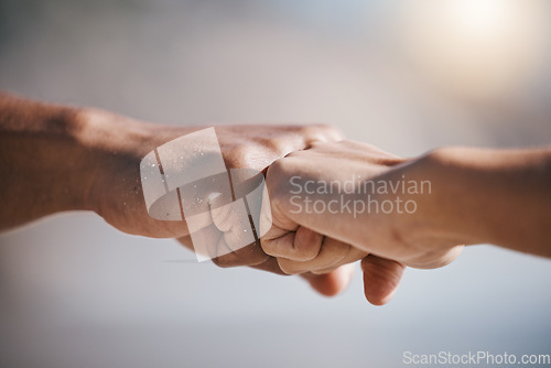 Image of Man, hands and fist bump for teamwork, partnership or unity in solidarity or community in the outdoors. Hand of friends bumping fists together for team goals, support or motivation in collaboration