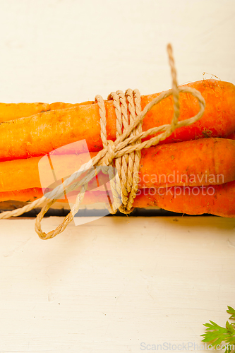 Image of baby carrots bunch tied with rope