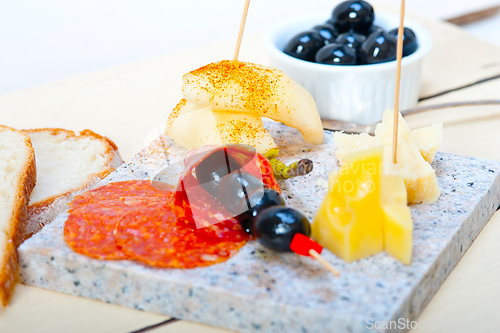 Image of mix cold cut on a stone with fresh pears