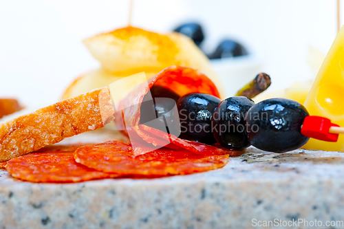 Image of mix cold cut on a stone with fresh pears