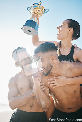 Image of Celebration, winning and volleyball team on the beach with a trophy for goals, success or achievement. Happy, celebrate and group of athletes in unity together by ocean or sea on summer weekend trip.