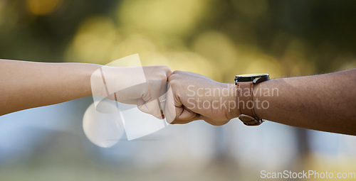 Image of Hands, motivation and fist bump with people outdoor on a blurred background for unity or solidarity. Teamwork, partnership and trust with friends outside together for team building or support