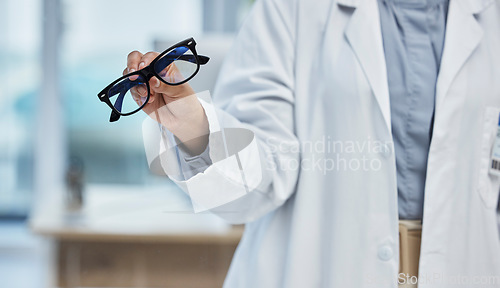 Image of Optometry, health and closeup of a optometrist with glasses at optical store or clinic. Eye care, wellness and zoom of optician or medical worker with prescription spectacles or eyewear frame at shop