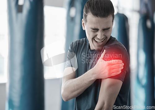 Image of Hand, shoulder pain and the arm of a man in red highlight during a fitness workout. Healthcare, medical and emergency with a male athlete holding his joint after an accident or injury in the gym