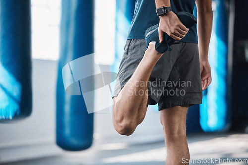 Image of Back, fitness and stretching with a sports man in the gym getting ready for a workout or training routine. Exercise, health and warm up with a male athlete in preparation of a workout for wellness