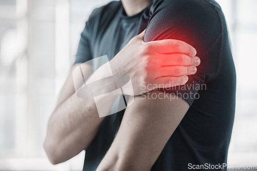 Image of Hand, shoulder pain and injury with the arm of a man in red highlight during a fitness workout. Healthcare, medical and emergency with a male athlete holding a joint after an accident in the gym