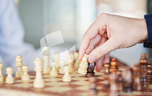 Image of Playing, board game and chess checkmate with a man at a table while moving piece for strategy or challenge. Hands of a male person to play, relax and bond while moving icon for problem solving or win